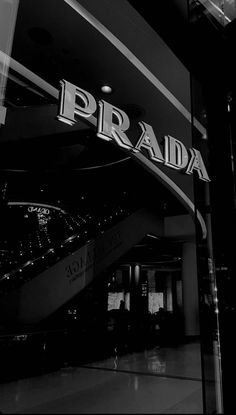 a black and white photo of the prada sign