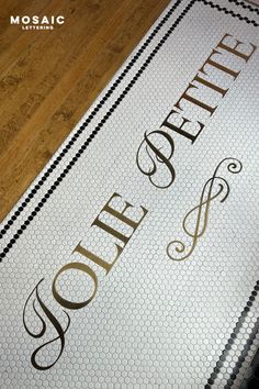 a white and black tile floor with gold lettering on it that says soffet