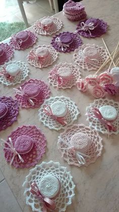 many crocheted doily are laid out on the table