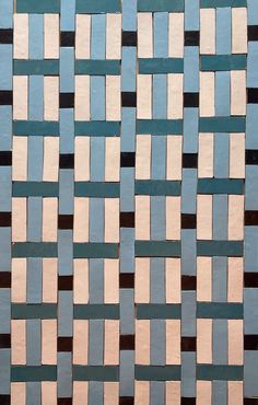 a close up view of a blue and white tile wall with different colored squares on it