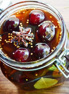 a glass jar filled with liquid sitting on top of a wooden table