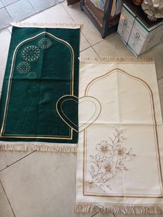 two green and white rugs sitting on top of a floor next to each other