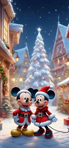 mickey and minnie mouse standing in front of a christmas tree