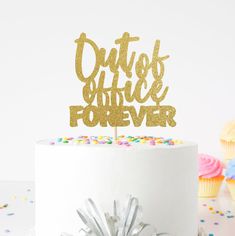 a white cake topped with a gold glitter duster