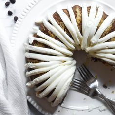 a white plate topped with a bundt cake covered in icing