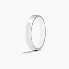 a plain white wedding ring on a white background