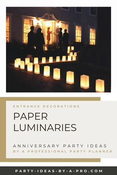 paper luminaries are lit up in front of a house with people standing outside