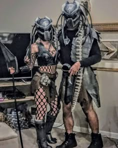 two people dressed up as aliens standing next to each other