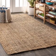 a living room area with a rug, couch and coffee table