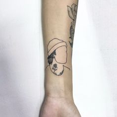 a person with a hat on their arm