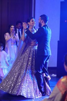 a man and woman dancing on stage at a wedding