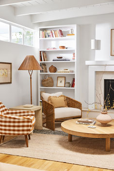 a living room filled with furniture and a fire place in front of a book shelf