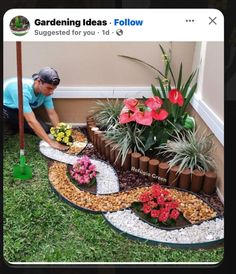 a man kneeling down to plant flowers in front of a flower bed on the ground