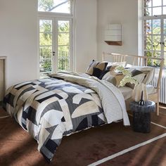 a bedroom with a bed, chair and window in it's centerpieces