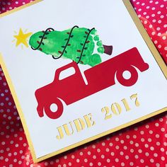 a red truck with a christmas tree on it's back and the words june written in gold