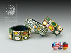 three bracelets with different designs on them and two balls in front of the image