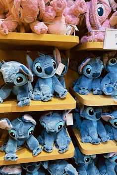 many stuffed animals are on shelves in a store