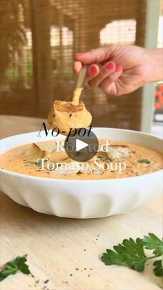 a person dipping some food into a bowl