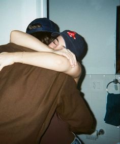 two people hugging each other in the kitchen