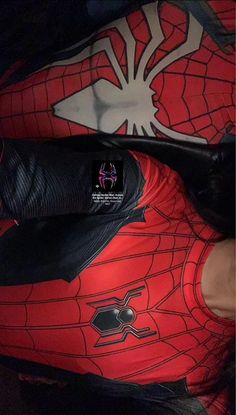 a person wearing red and black spider - man tights with their feet on the ground