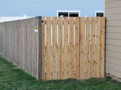 a wooden fence in front of a house