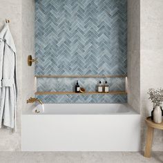 a white bath tub sitting next to a wooden shelf