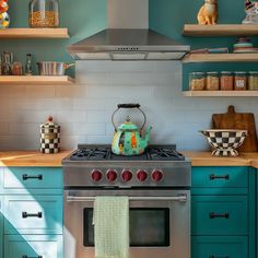 a teal colored stove in a kitchen with open shelves