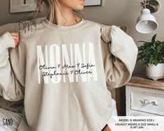 Elevate the joy of Mother's Day with our Personalized Nonna sweatshirt adorned with the sweet touch of grandkid names. This Nonna sweatshirt creates a heartfelt and stylish tribute to the cherished Nonna in your life. ✨Please check the SIZE CHART image on the listing, and choose your size accordingly before placing your order.  🚫We do not accept exchanges, returns, or cancellations, however, if there are any quality issues with the item please contact us right away. We'll be happy to make thing Nonnie Shirts, Nonna Shirts Design, Embroidered Grandma Sweatshirt, Grandma And Grandpa Sweatshirts, Nonna Gifts, Mother's Day Personalized Crew Neck T-shirt, The Sweet, Mother's Day Gifts, Mother's Day