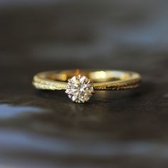 a close up of a diamond ring on a table