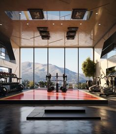 a gym with large windows overlooking the mountains