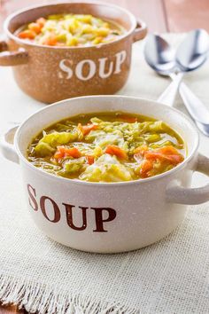 two bowls filled with soup sitting on top of a table