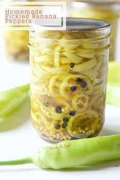 a jar filled with pasta and beans next to green peppers