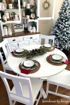 a dining room table with plates and christmas decorations on it