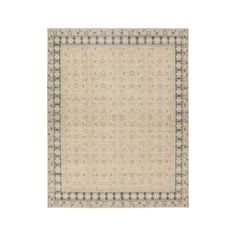 a beige rug with blue and white accents on the bottom, in front of a white background