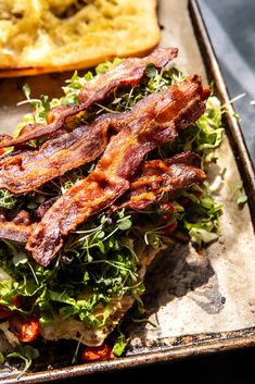 bacon and lettuce are on top of bread