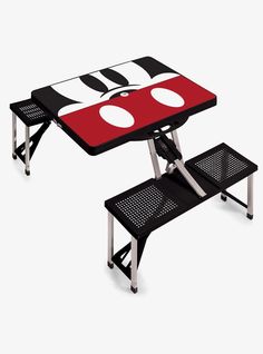 a picnic table with a mickey mouse design on the top and two benches underneath it