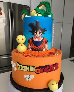 a birthday cake decorated with an image of gohan and dragon on the top tier