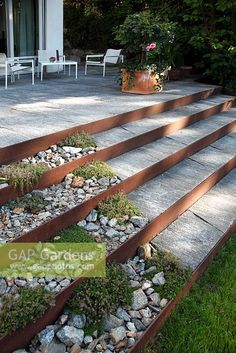 the steps are made out of wood and have plants growing on them, along with gravel