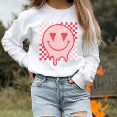 Retro Smiley Face sweatshirt, Distressed Vintage Look Smiley face, Crewneck sweatshirt, Retro smile, smile graphic sweater, valentines, melted smiley face, good vibes, positivity, Be Happy, Brahman Darlin Thank you for shopping my small business. Please message me if you have questions. This is a physical shirt that is made when you order it and shipped out to you. I do not sell my designs, they are made with love, by me to support my family's cattle ranch. If you love the design and would like Trendy Heart Graphic Tops For Loungewear, Casual Heart Graphic Top For Loungewear, Trendy Loungewear Tops With Heart Graphic, Trendy Smiley Face Loungewear Tops, Trendy Smiley Face Tops For Loungewear, Fun Cotton Tops For Leisure, Fun Relaxed Fit Tops For Leisure, Casual White Sweatshirt With Funny Print, Casual Cotton Sweatshirt With Funny Print