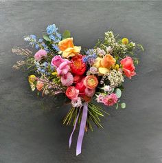 a bouquet of colorful flowers sitting on the ground