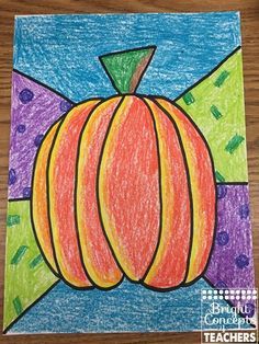 a drawing of a pumpkin on a piece of paper with colored pencils in the background