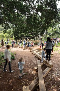 people are walking around in the park with wooden benches and steps leading up to them