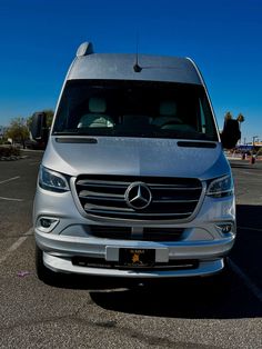 a mercedes van parked in a parking lot with no one around it on the side