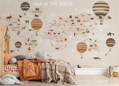 a child's bedroom with a map of the world wallpaper and hot air balloons