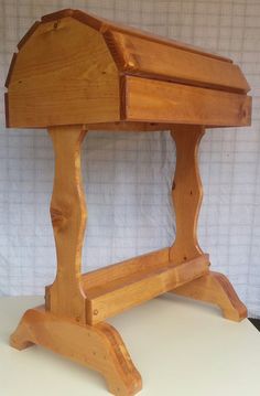 a wooden bench sitting on top of a white table