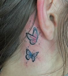 a woman's behind the ear tattoo with two butterflies