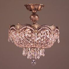 a chandelier hanging from the ceiling with crystal drops on it's sides