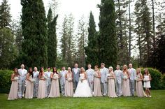 a large group of people standing in front of trees