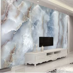 a living room with marble wallpaper and white furniture in front of the tv screen