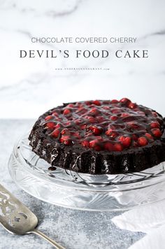 a chocolate covered cherry devil's food cake on a glass plate with a spoon